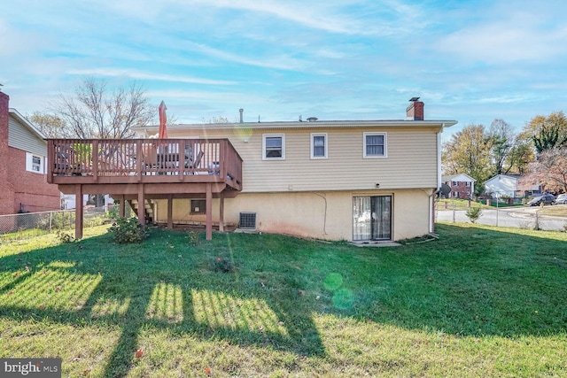 back of house featuring a lawn, cooling unit, and a wooden deck