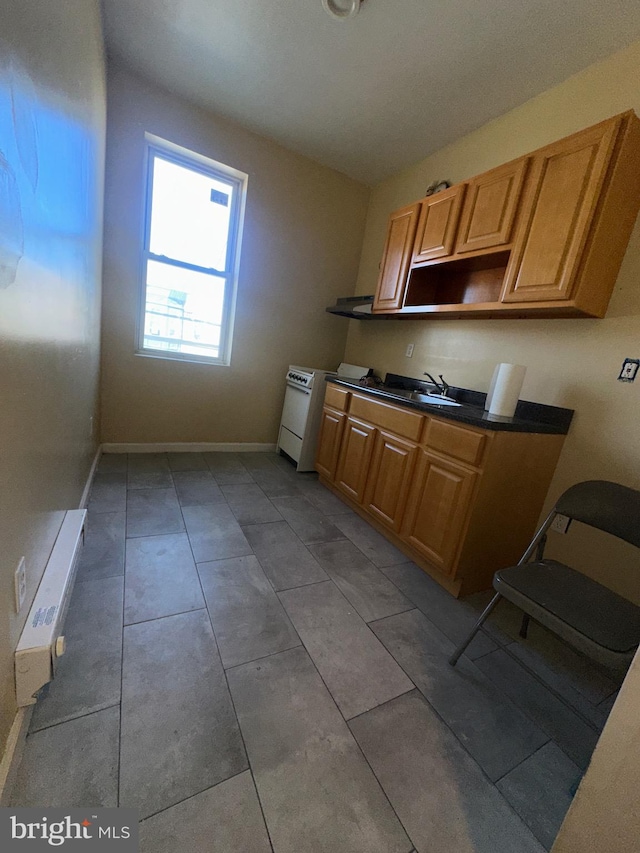 kitchen with light tile patterned floors and sink