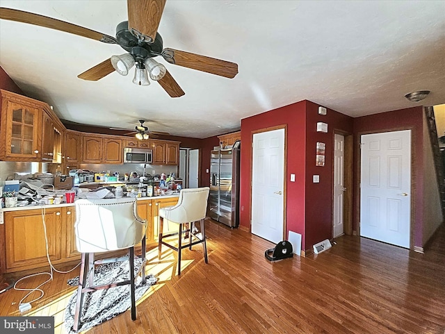 kitchen featuring hardwood / wood-style flooring, ceiling fan, and appliances with stainless steel finishes