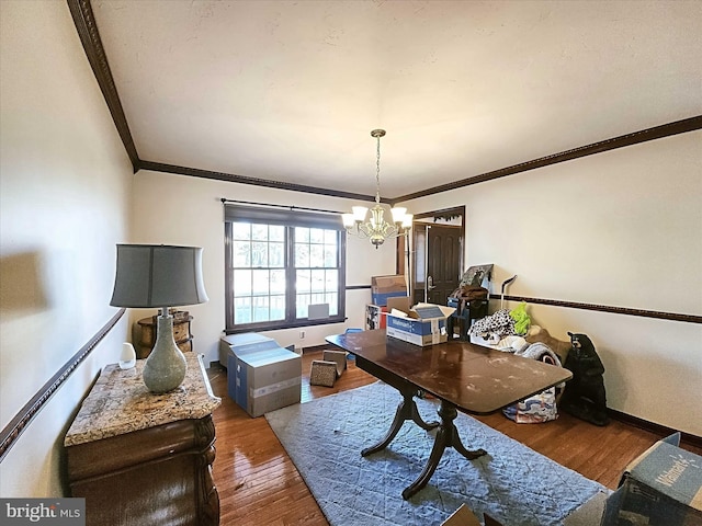 home office with crown molding, dark wood-type flooring, and an inviting chandelier