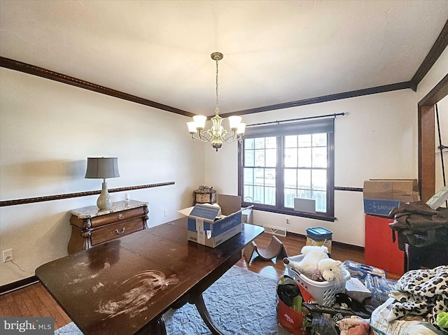 dining room with ornamental molding, dark wood-type flooring, and a notable chandelier