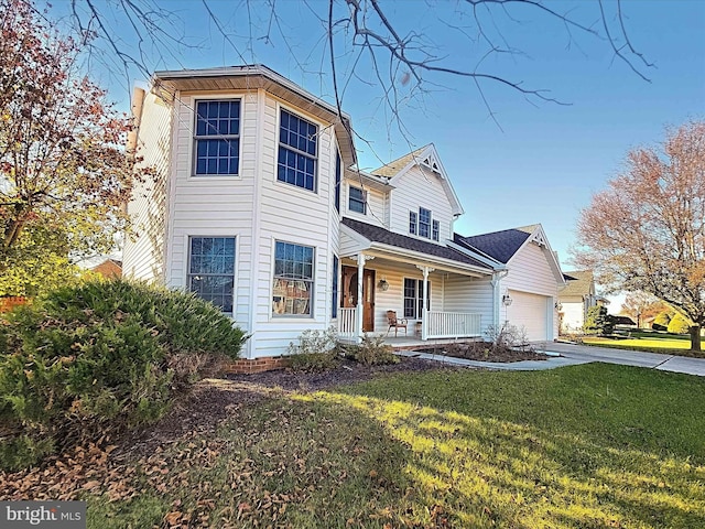 view of front of property with covered porch, a front yard, and a garage