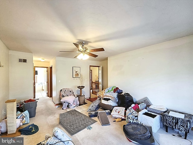 living room featuring carpet flooring and ceiling fan