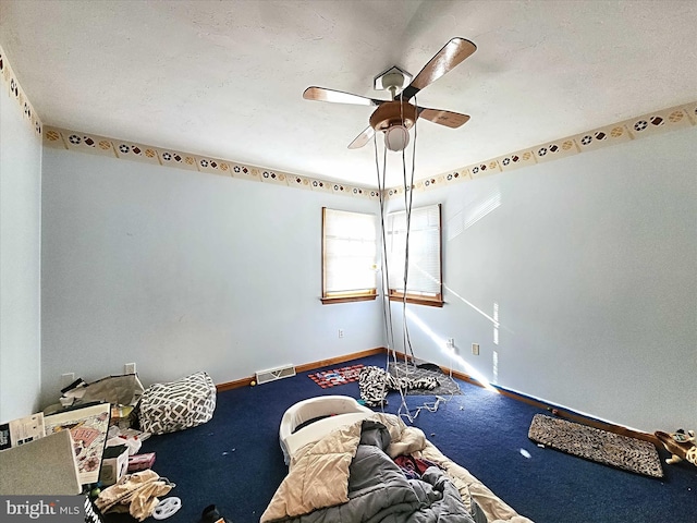 unfurnished bedroom with ceiling fan and carpet flooring