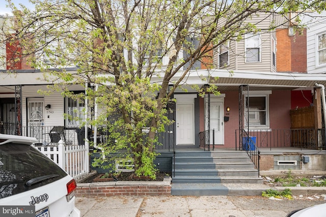 view of property featuring covered porch