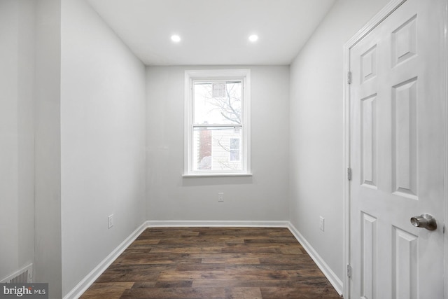 spare room with dark hardwood / wood-style flooring