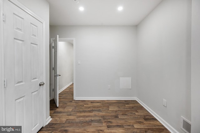 unfurnished room featuring dark hardwood / wood-style flooring