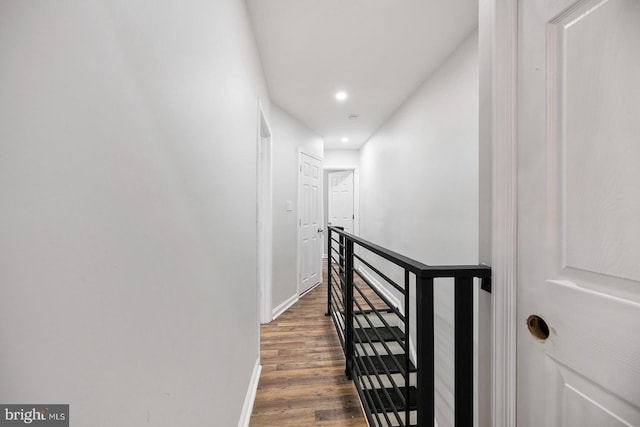 corridor with dark hardwood / wood-style flooring