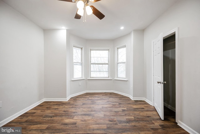 spare room featuring dark hardwood / wood-style floors and ceiling fan