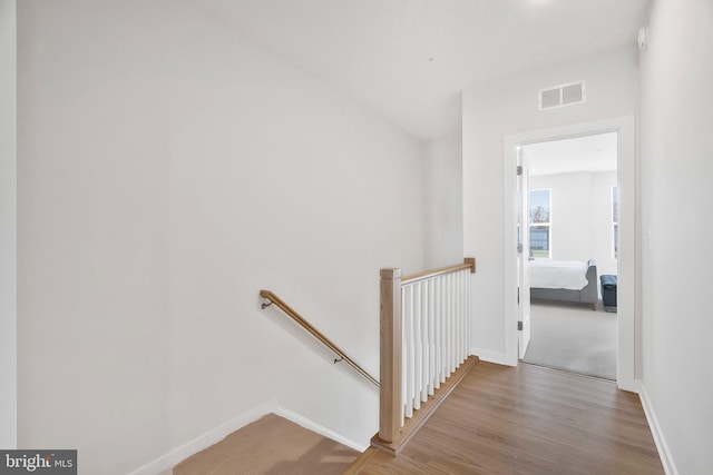 hallway with hardwood / wood-style floors