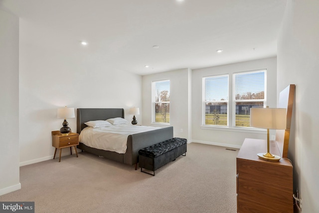 bedroom featuring light carpet