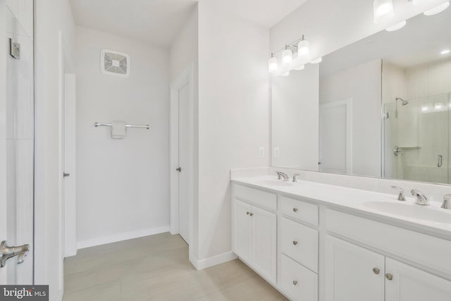 bathroom featuring vanity and a shower with shower door