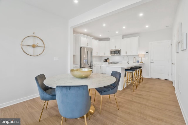 dining room featuring light hardwood / wood-style floors and sink