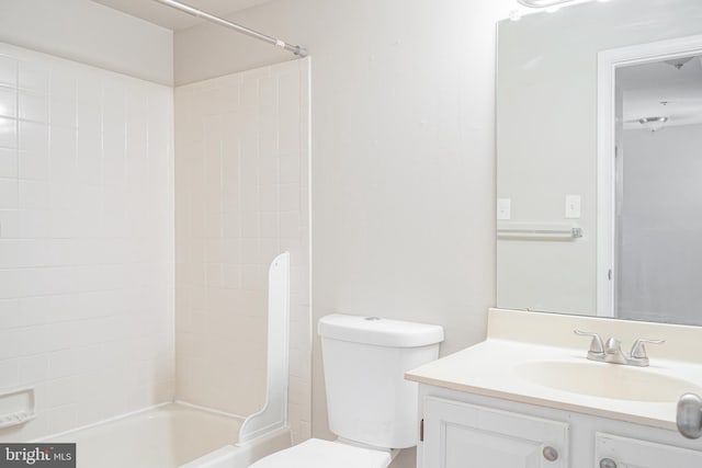 full bathroom featuring toilet, tiled shower / bath combo, and vanity