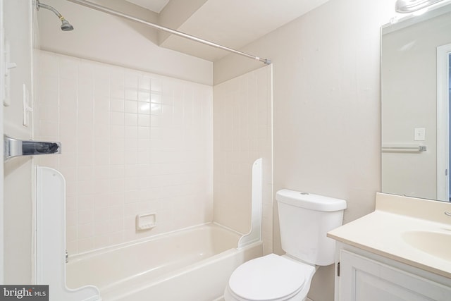 full bathroom with vanity, tiled shower / bath combo, and toilet