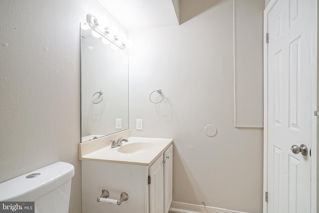 bathroom with toilet and vanity