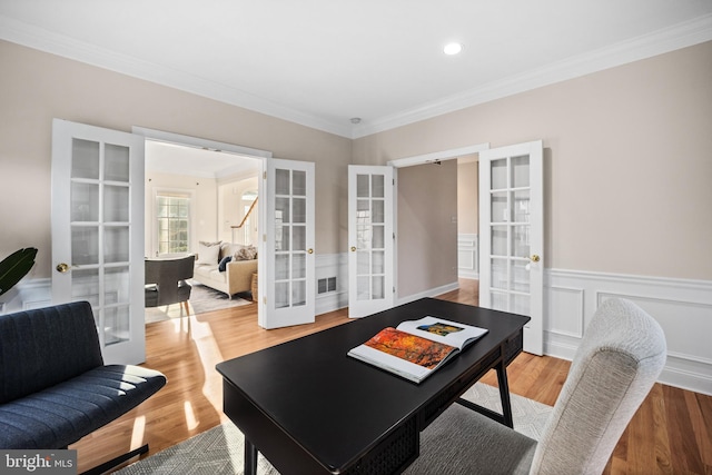 office space featuring french doors, hardwood / wood-style flooring, and crown molding