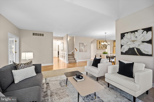 living room with hardwood / wood-style flooring and a chandelier