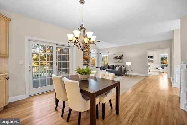 dining area featuring light hardwood / wood-style floors and a notable chandelier