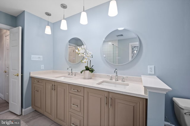 bathroom featuring tile patterned floors, vanity, and toilet