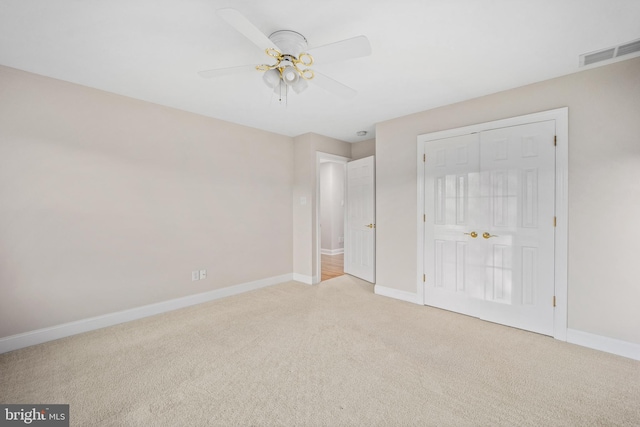 unfurnished bedroom featuring carpet, ceiling fan, and a closet