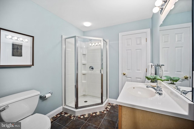 bathroom with toilet, vanity, tile patterned flooring, and a shower with door