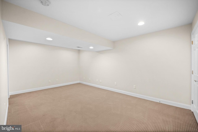 basement featuring light colored carpet