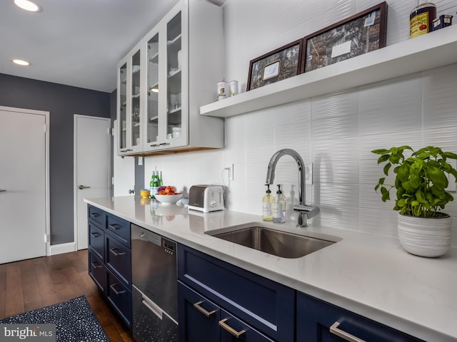 kitchen with dishwasher, dark hardwood / wood-style flooring, sink, and blue cabinetry