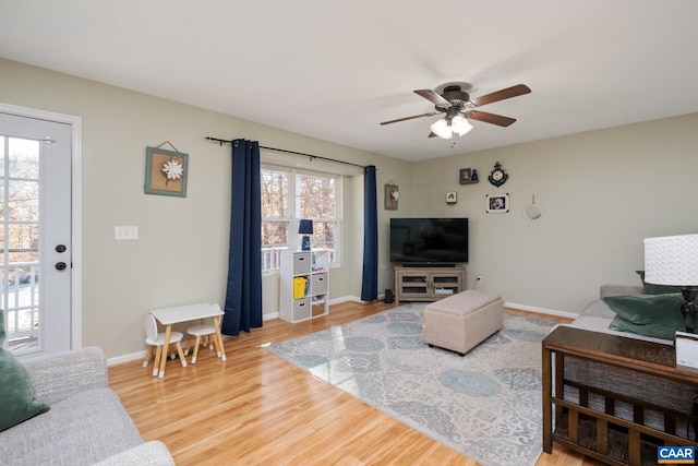 living room with hardwood / wood-style flooring, ceiling fan, and a healthy amount of sunlight