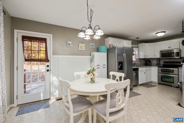 dining room with sink and an inviting chandelier