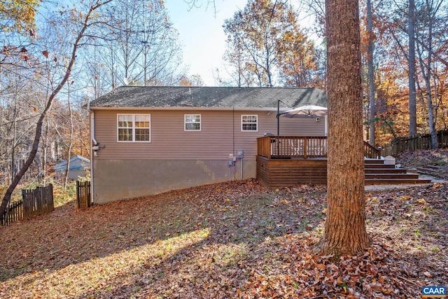 rear view of property featuring a wooden deck