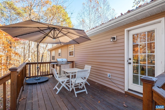 wooden terrace featuring a grill