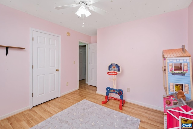 game room with hardwood / wood-style floors and ceiling fan