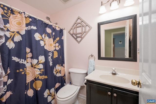 bathroom featuring tile patterned flooring, vanity, and toilet