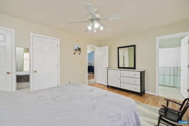 bedroom featuring ensuite bathroom, light hardwood / wood-style flooring, and ceiling fan