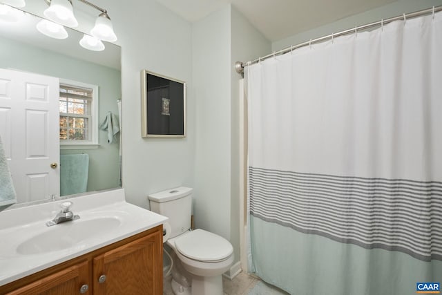 bathroom featuring tile patterned flooring, vanity, and toilet