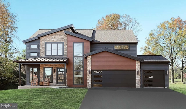 view of front facade with an attached garage, driveway, a front yard, and stone siding