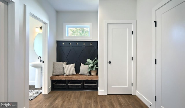 mudroom with wood finished floors and baseboards