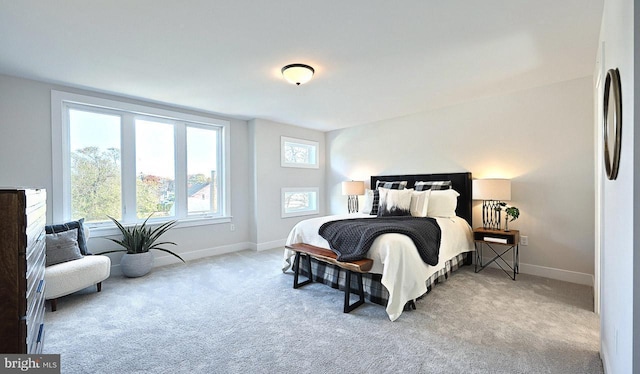 carpeted bedroom with baseboards