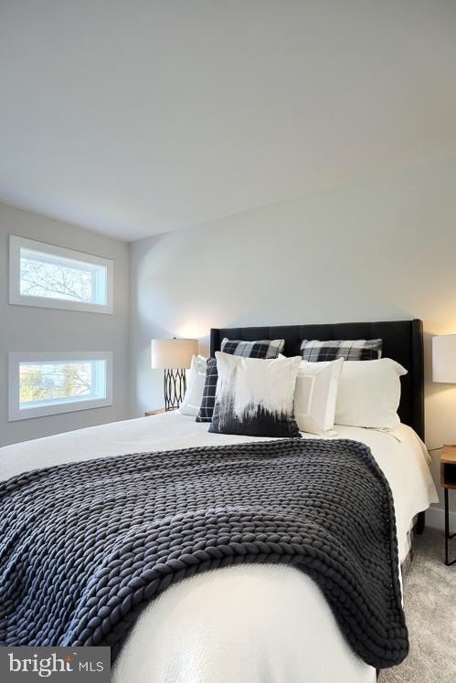 bedroom featuring light colored carpet