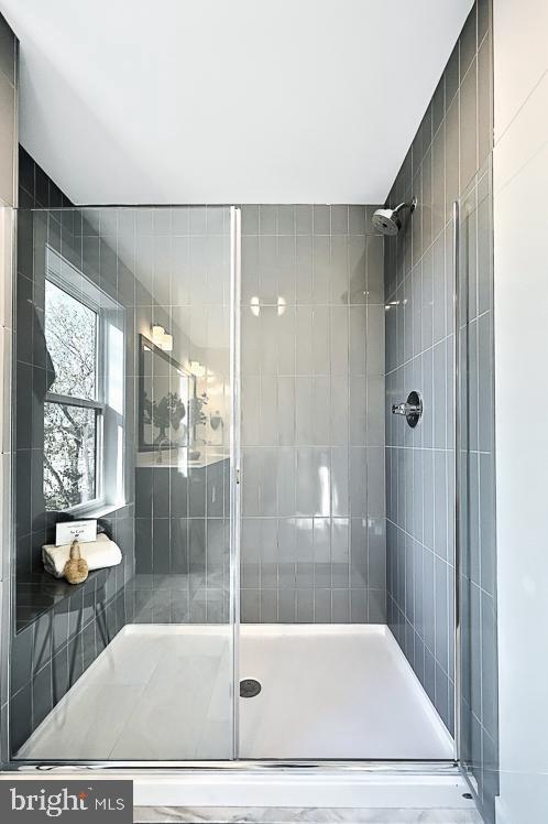 full bath featuring a shower stall