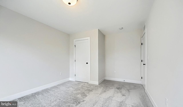 spare room featuring light colored carpet