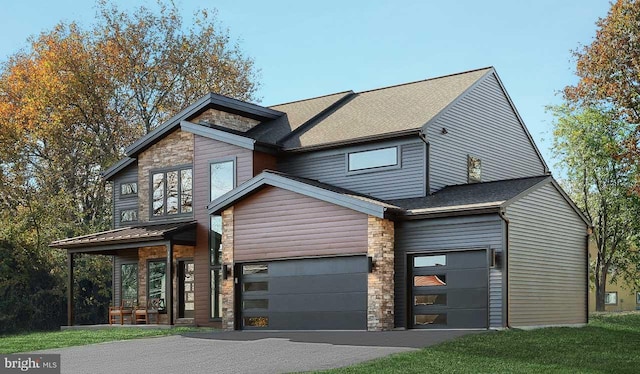 modern home with stone siding, driveway, roof with shingles, and an attached garage