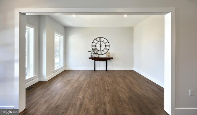 unfurnished dining area featuring dark hardwood / wood-style flooring