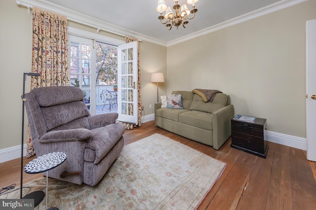 living room featuring a chandelier, hardwood / wood-style floors, and crown molding