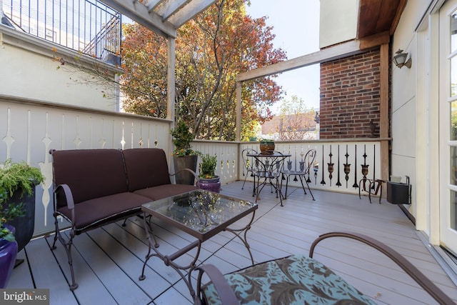 wooden terrace with an outdoor hangout area