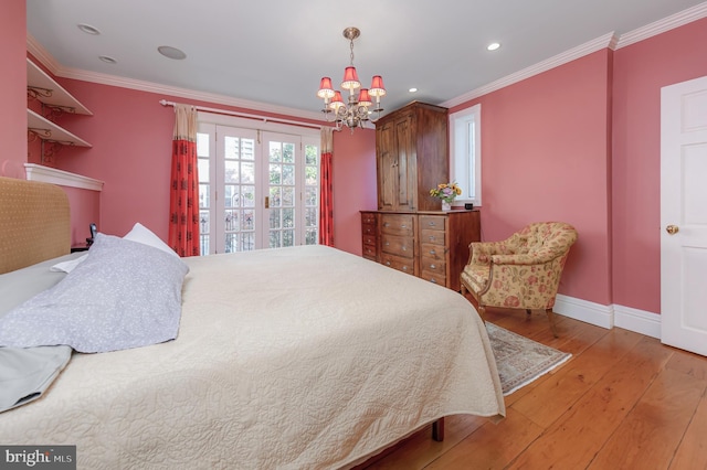 bedroom with an inviting chandelier, light hardwood / wood-style flooring, and ornamental molding