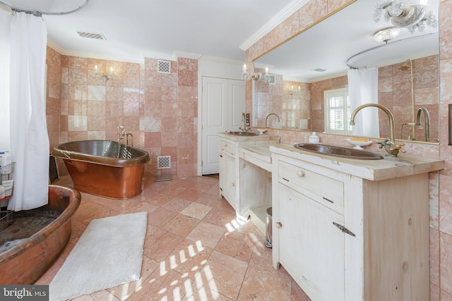 bathroom with a tub, crown molding, vanity, and tile walls