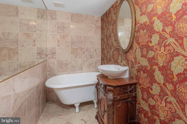 bathroom featuring sink, tile walls, and a washtub