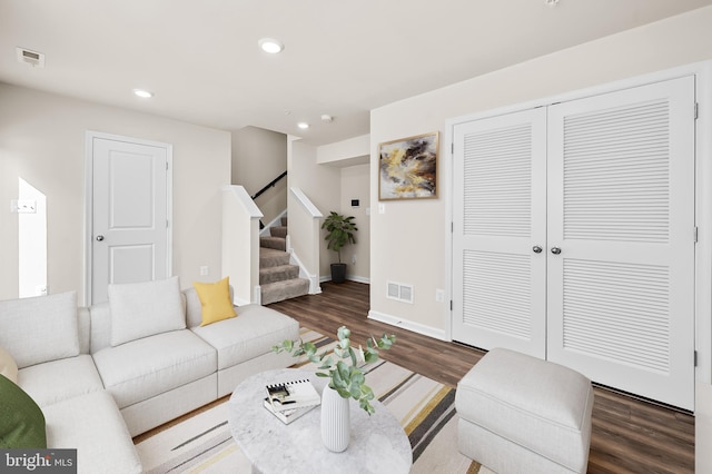 living room featuring dark wood-type flooring